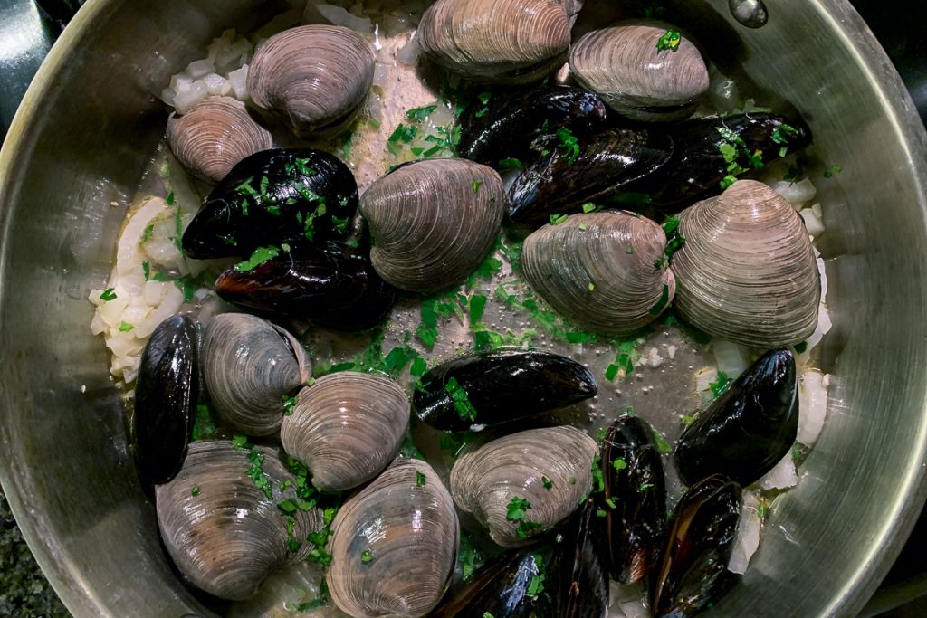 Mussels and Clams Cooking with Parsley