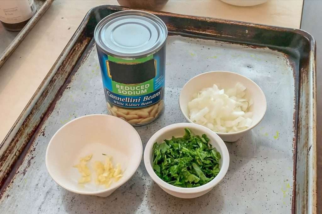 White beans with garlic and herbs is one of the easiest and most versatile side dishes -- Four ingredients that adapt to fit your needs